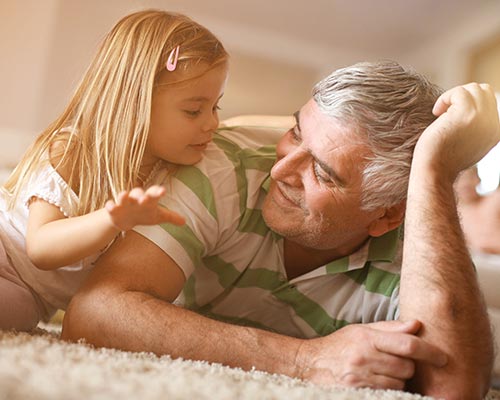 A Grandad relaxing with his granddaughter