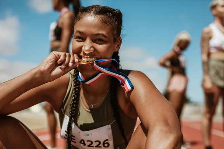 Women with medal after breaking a record